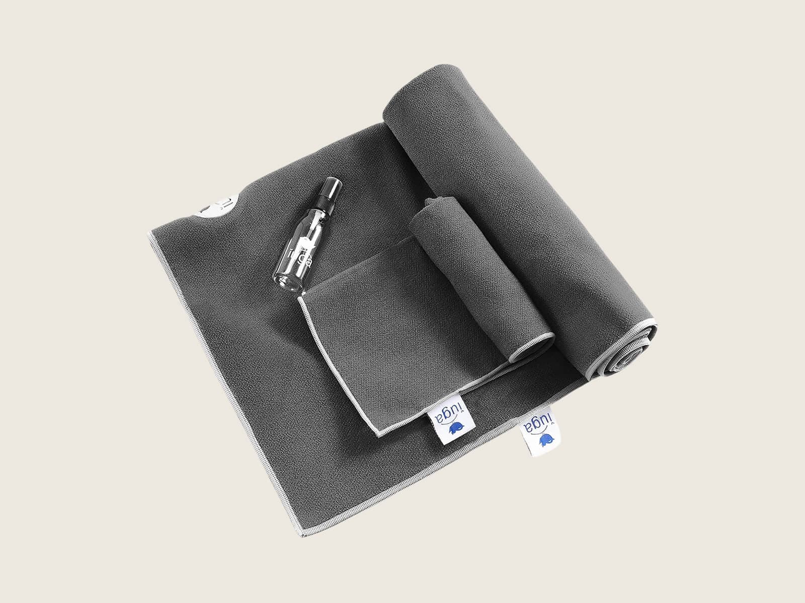 IUGA hot yoga towel with corner pockets tucked over a mat, plus a hand towel
