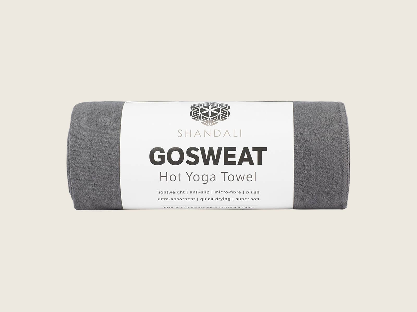 Shandali GoSweat hot yoga towel laid over a mat in a studio